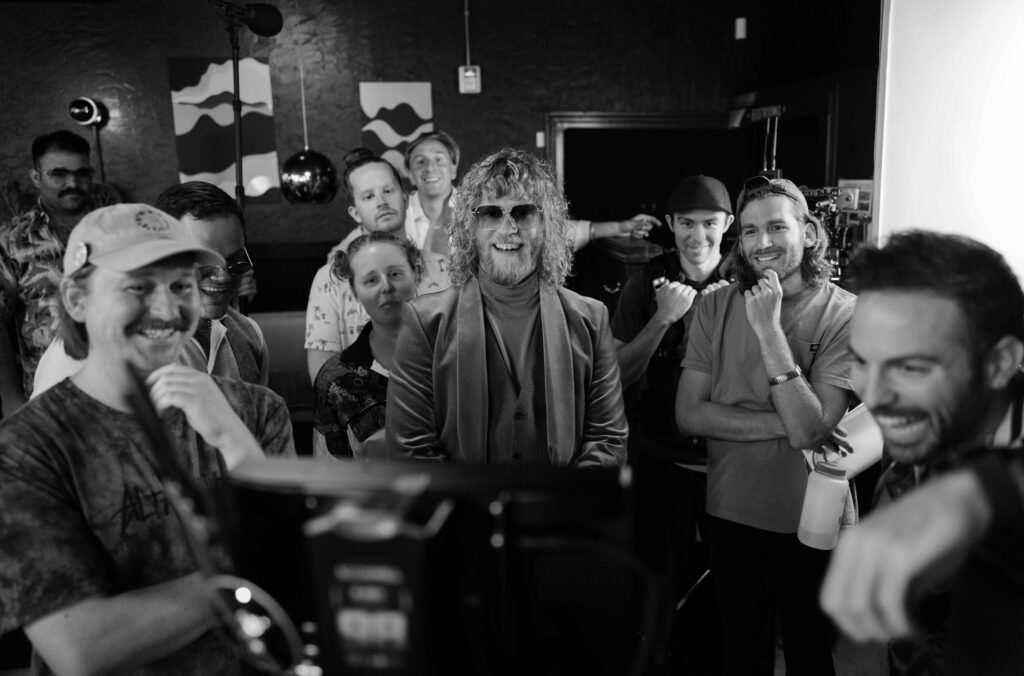 The Offbeat Films crew and actors watch a playback of a one-take shot on the set of a new Allen Stone (center) tour promotional video at Lucky You Lounge in Spokane, Wash. Monday August 15, 2022. (Photo by Rajah Bose)